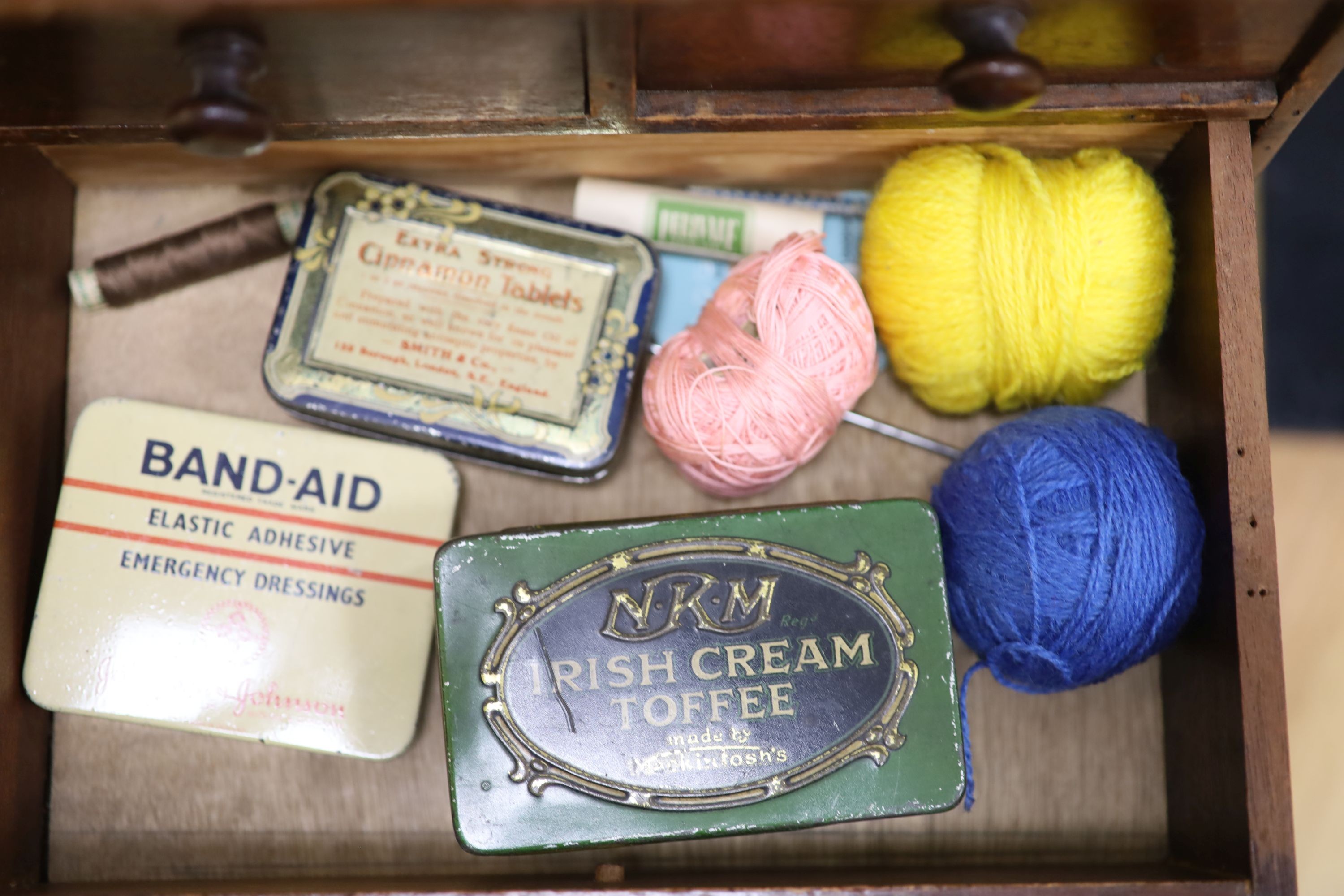 An early 20th century miniature chest and contents